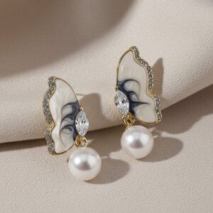 Butterfly-inspired pearl drop earrings.