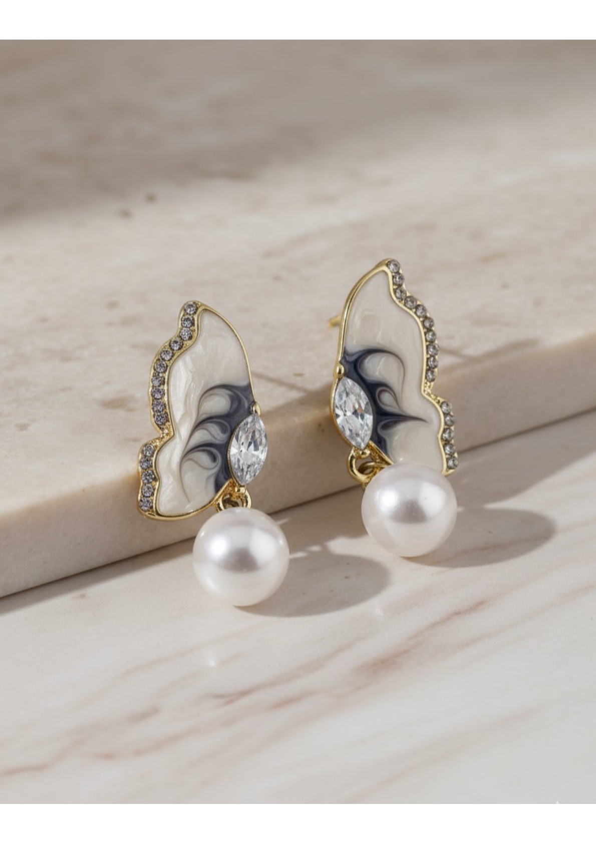 Butterfly-inspired pearl drop earrings. - Image 4